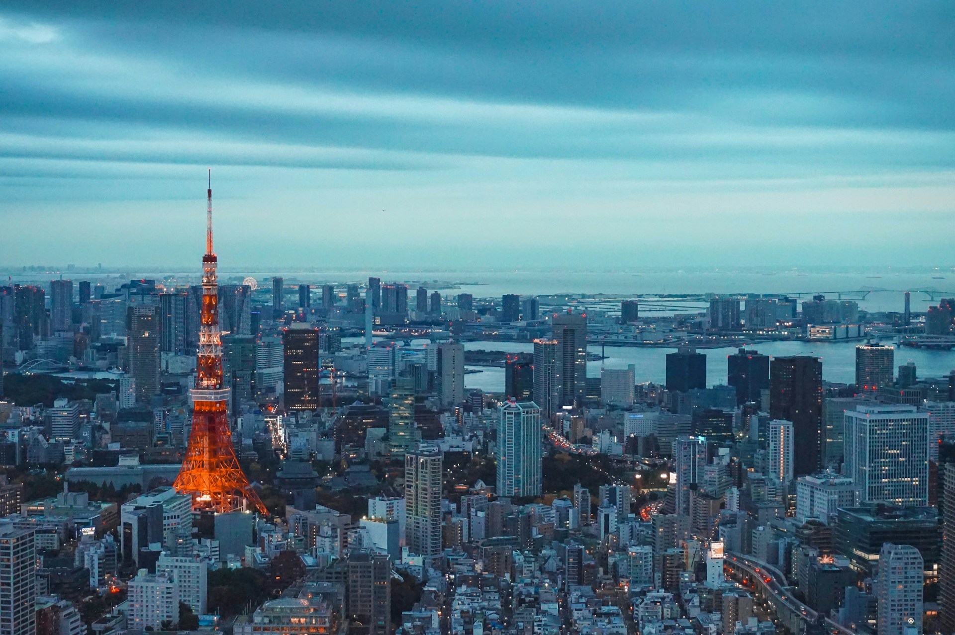 The image showcases a stunning aerial view of Tokyo at dusk